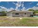 Side view of home showcasing well maintained lawn and property, featuring windows and exterior water and gas fixtures at 6338 Oak E Sq, Lakeland, FL 33813