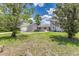 Charming home exterior featuring lush front yard with mature trees and well-manicured lawn and a detached garage at 6338 Oak E Sq, Lakeland, FL 33813