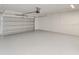 Spacious garage featuring bright lighting, a clean floor, and a modern garage door at 6338 Oak E Sq, Lakeland, FL 33813