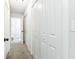 A hallway has white doors with matte black hardware and light gray carpet at 6338 Oak E Sq, Lakeland, FL 33813