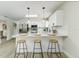 Modern kitchen featuring stainless steel appliances, a breakfast bar with seating, and white cabinetry at 6338 Oak E Sq, Lakeland, FL 33813