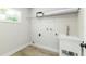 A simple laundry room features a utility sink and a wire shelf at 6338 Oak E Sq, Lakeland, FL 33813