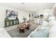 Stylish living room showcases an open layout, blending seamlessly with the modern kitchen and dining area at 6338 Oak E Sq, Lakeland, FL 33813