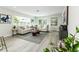 Spacious living room with neutral tones, modern furniture, large windows, and stylish décor at 6338 Oak E Sq, Lakeland, FL 33813