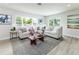 Bright and airy living room with comfortable seating, large windows, and tasteful decor at 6338 Oak E Sq, Lakeland, FL 33813