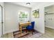 A small office features a bright blue chair and a light colored wood desk at 6338 Oak E Sq, Lakeland, FL 33813