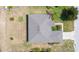 Birds eye view of a grey roof single Gathering home surrounded by sparse backyard landscape at 6339 Alamanda Hills Dr, Lakeland, FL 33813