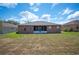 Backyard with a well-maintained lawn, screened in patio, and open space at 6339 Alamanda Hills Dr, Lakeland, FL 33813
