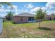 A backyard featuring well-maintained lawn, an open area, and a screened in patio at 6339 Alamanda Hills Dr, Lakeland, FL 33813