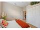 A bedroom showcasing a bright white closet and orange blanket on the bed at 6339 Alamanda Hills Dr, Lakeland, FL 33813