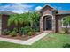 Inviting front entrance with stone pillars, a 'welcome' sign, and lush landscaping at 6339 Alamanda Hills Dr, Lakeland, FL 33813