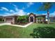 Charming single-story home with a well-manicured lawn, stone accents, and a two-car garage at 6339 Alamanda Hills Dr, Lakeland, FL 33813