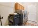 Laundry room with appliances, storage, and a convenient layout at 6339 Alamanda Hills Dr, Lakeland, FL 33813
