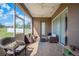 Screened patio with seating, string lights, and serene views of the yard at 6339 Alamanda Hills Dr, Lakeland, FL 33813