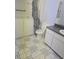 Functional bathroom with safety tub, vanity, and patterned tile flooring at 6632 Sweetbriar Ln, Lakeland, FL 33813
