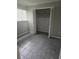 Bedroom with tiled floor, closet with open doors, and ample natural light at 6632 Sweetbriar Ln, Lakeland, FL 33813