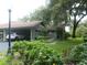 Charming home with a carport and lush landscaping, creating an inviting curb appeal at 6632 Sweetbriar Ln, Lakeland, FL 33813
