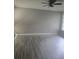 Bright room featuring wood-look flooring, ceiling fan, and natural light, ideal for a cozy living space at 6632 Sweetbriar Ln, Lakeland, FL 33813