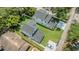 Aerial view of two homes with a well-manicured lawn, private driveways and mature trees at 727 S Missouri Ave, Lakeland, FL 33815