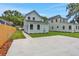 Backyard view featuring a new cement patio, lush green grass, and modern pale-blue siding at 727 S Missouri Ave, Lakeland, FL 33815