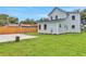 Backyard view featuring a new cement patio, lush green grass, and modern pale-blue siding at 727 S Missouri Ave, Lakeland, FL 33815
