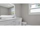 Modern bathroom features a white double vanity and a large, lighted mirror at 727 S Missouri Ave, Lakeland, FL 33815