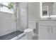 Modern bathroom features a glass shower, toilet, vanity, and lighted mirror at 727 S Missouri Ave, Lakeland, FL 33815