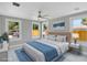 Virtually staged bedroom featuring a soft rug, upholstered headboard, and three sunny windows at 727 S Missouri Ave, Lakeland, FL 33815