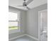 Bright bedroom features neutral walls, a window, ceiling fan, and en suite bathroom at 727 S Missouri Ave, Lakeland, FL 33815