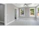 Spacious bedroom featuring three windows, ensuite bath, and modern gray walls and trim at 727 S Missouri Ave, Lakeland, FL 33815