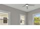 Bedroom featuring multiple windows allowing for natural light, and a modern ceiling fan at 727 S Missouri Ave, Lakeland, FL 33815