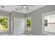 Bedroom with natural light from the three windows, plus a modern ceiling fan and a double door closet at 727 S Missouri Ave, Lakeland, FL 33815