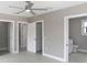 Neutral bedroom features ceiling fan, three doors, and an en suite bathroom at 727 S Missouri Ave, Lakeland, FL 33815