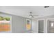 Bright room features neutral walls, two windows, ceiling fan, and en suite bathroom at 727 S Missouri Ave, Lakeland, FL 33815