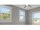A bedroom featuring three windows providing ample natural light with a ceiling fan at 727 S Missouri Ave, Lakeland, FL 33815