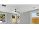 Bright bedroom featuring a ceiling fan, three windows, and neutral walls for a serene atmosphere at 727 S Missouri Ave, Lakeland, FL 33815