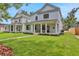 Charming home featuring a covered porch and lush lawn in a serene neighborhood setting at 727 S Missouri Ave, Lakeland, FL 33815