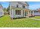 Attractive two-story home showcasing a covered porch and well-maintained lawn at 727 S Missouri Ave, Lakeland, FL 33815