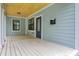 Spacious front porch with a light-wood ceiling and room for seating and relaxing at 727 S Missouri Ave, Lakeland, FL 33815