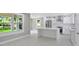 Bright open-concept kitchen with an island, stainless steel appliances, and modern white cabinetry at 727 S Missouri Ave, Lakeland, FL 33815