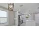 Bright kitchen features stainless steel appliances, white cabinetry, quartz counters, and a modern light fixture at 727 S Missouri Ave, Lakeland, FL 33815