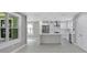 Contemporary kitchen features an island, stainless steel refrigerator, and lots of natural light at 727 S Missouri Ave, Lakeland, FL 33815