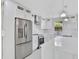 Close up of modern kitchen with stainless steel appliances, white cabinets, and quartz countertops at 727 S Missouri Ave, Lakeland, FL 33815