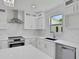 Well-lit kitchen showcasing stainless steel appliances, quartz countertops, and bright cabinetry at 727 S Missouri Ave, Lakeland, FL 33815
