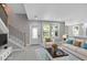 Staged living room with a staircase and lots of natural light from the picture window at 727 S Missouri Ave, Lakeland, FL 33815