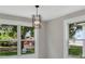 Bright and airy living room featuring large windows that provide ample natural light and neighborhood views at 727 S Missouri Ave, Lakeland, FL 33815