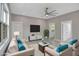 Staged living room with white sofas and chairs, a plant, and a large ceiling fan at 727 S Missouri Ave, Lakeland, FL 33815