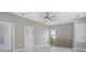 Light filled loft with ceiling fan, staircase railing, and adjacent bathroom at 727 S Missouri Ave, Lakeland, FL 33815