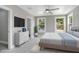 Bright main bedroom features neutral walls, two windows, ceiling fan, and en suite bathroom at 727 S Missouri Ave, Lakeland, FL 33815