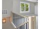 Staircase with white trim, black railing, and a hanging light fixture at 727 S Missouri Ave, Lakeland, FL 33815